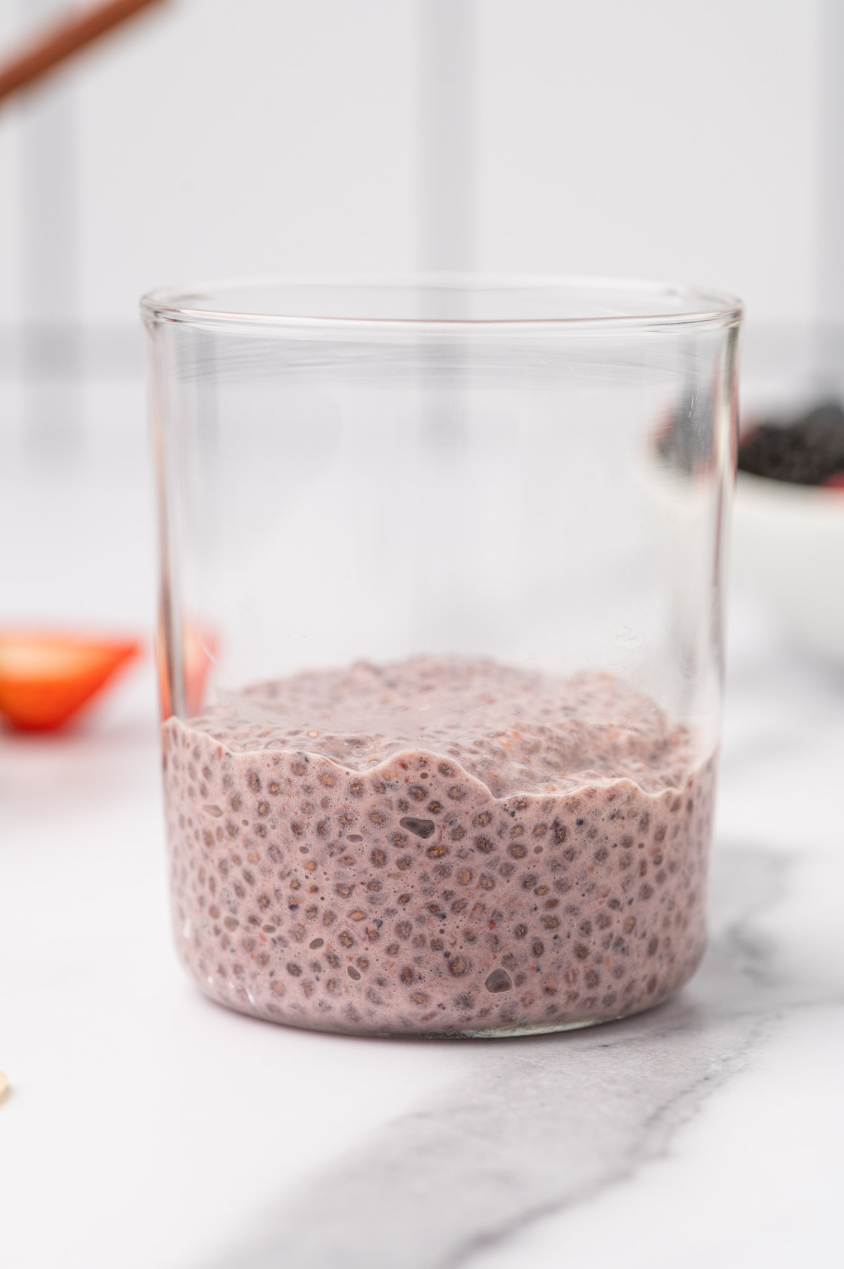 Berry chia seed pudding added to the glass jar