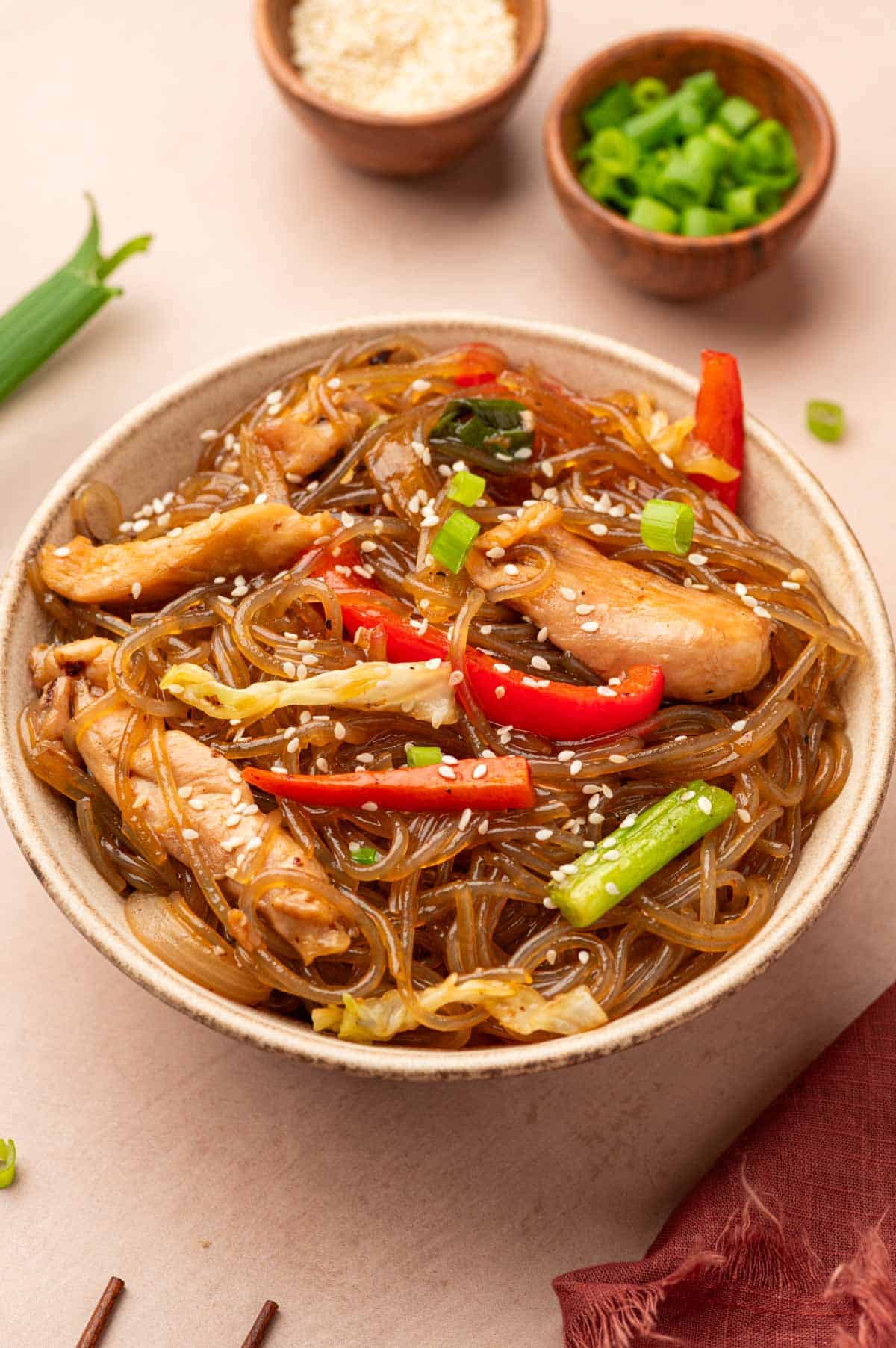 Glass chicken noodles stir fry in a bowl