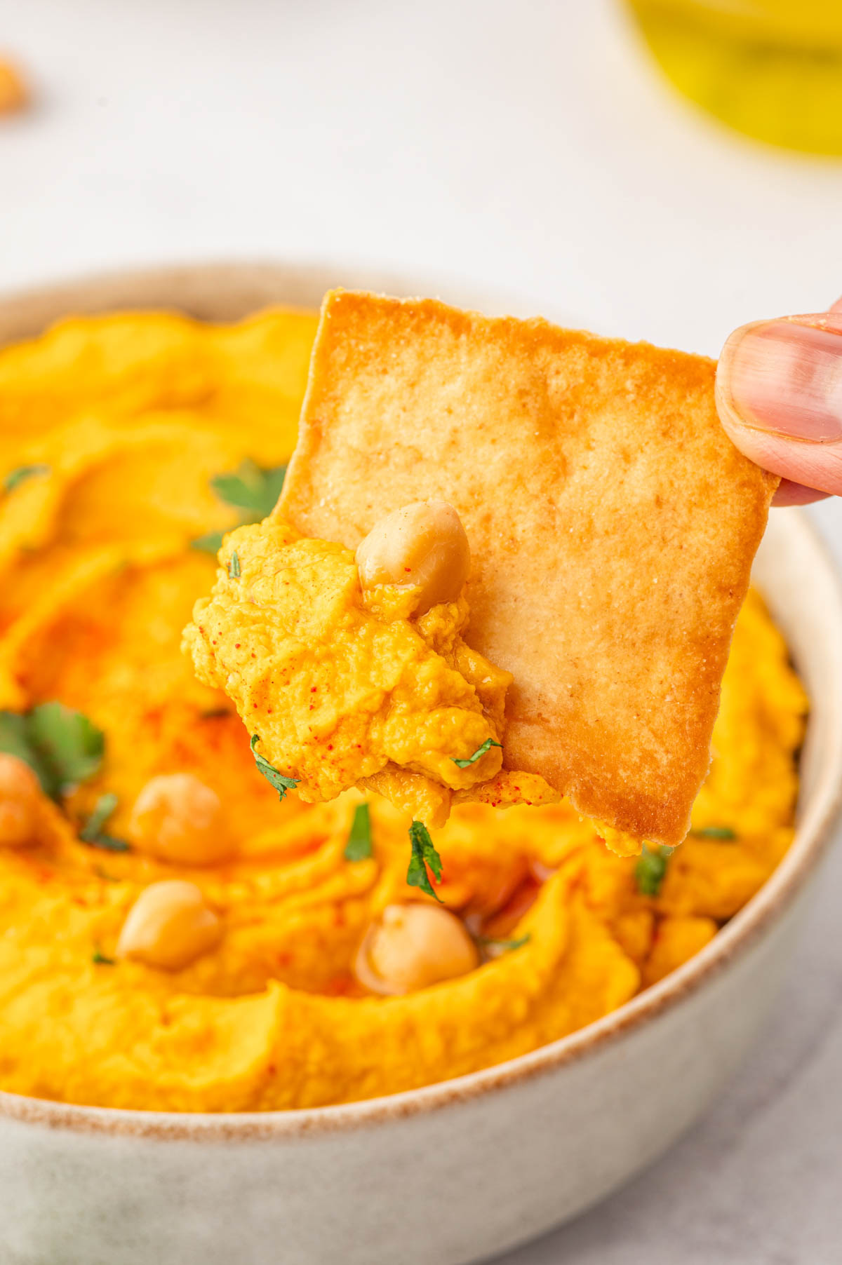 Roasted carrot hummus with canned chickpeas-close up shot with pita chips