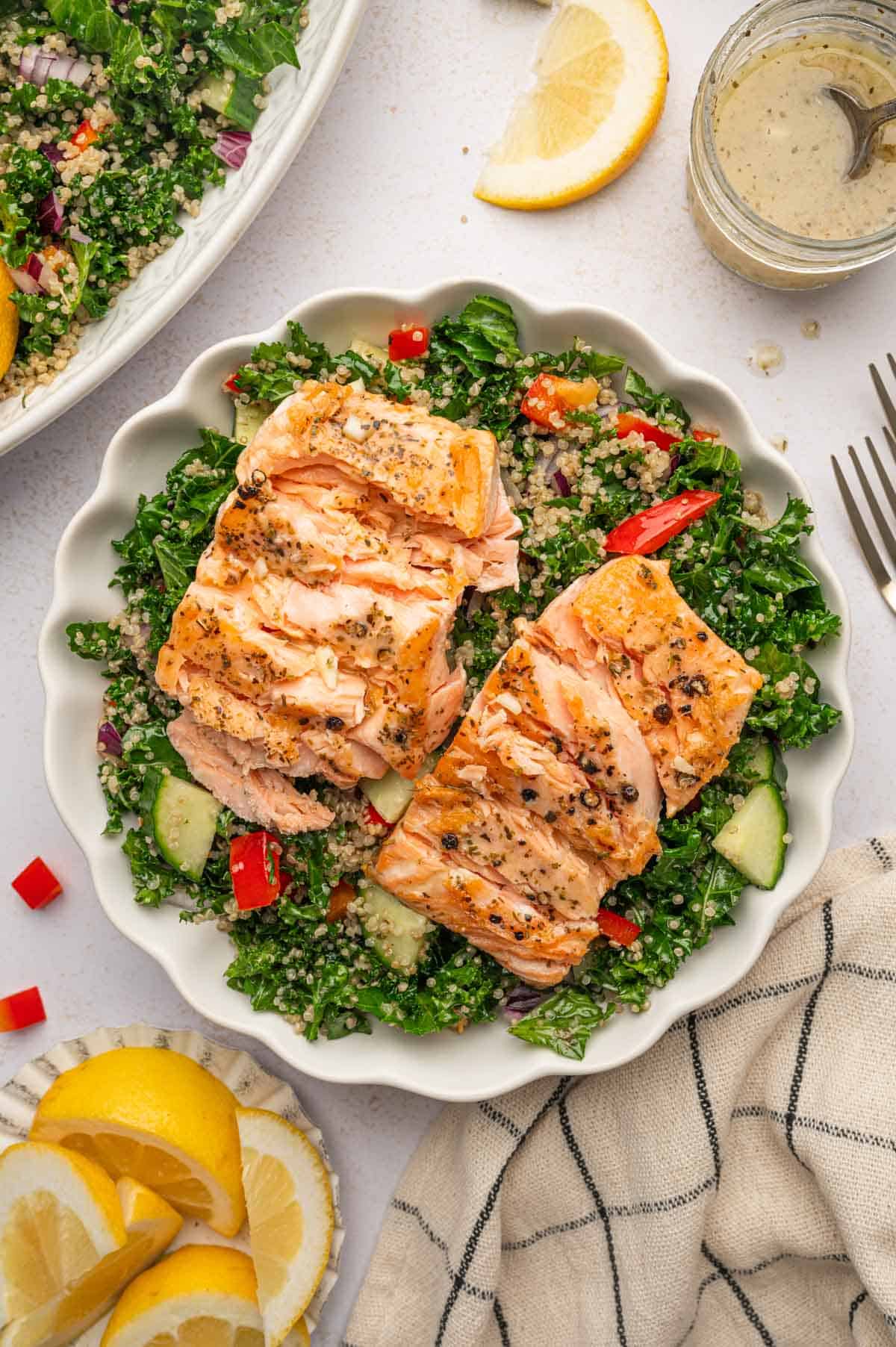 Salmon Kale Quinoa Salad is served in a white bowl