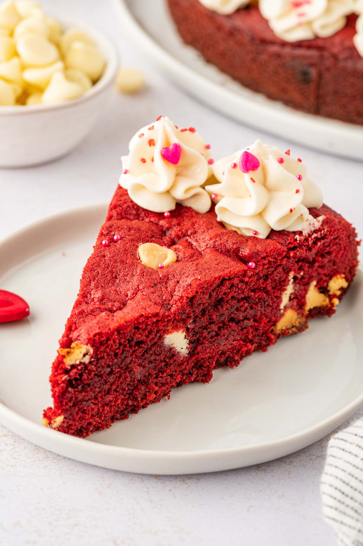 a piece of red velevt cookie cake in a white plate