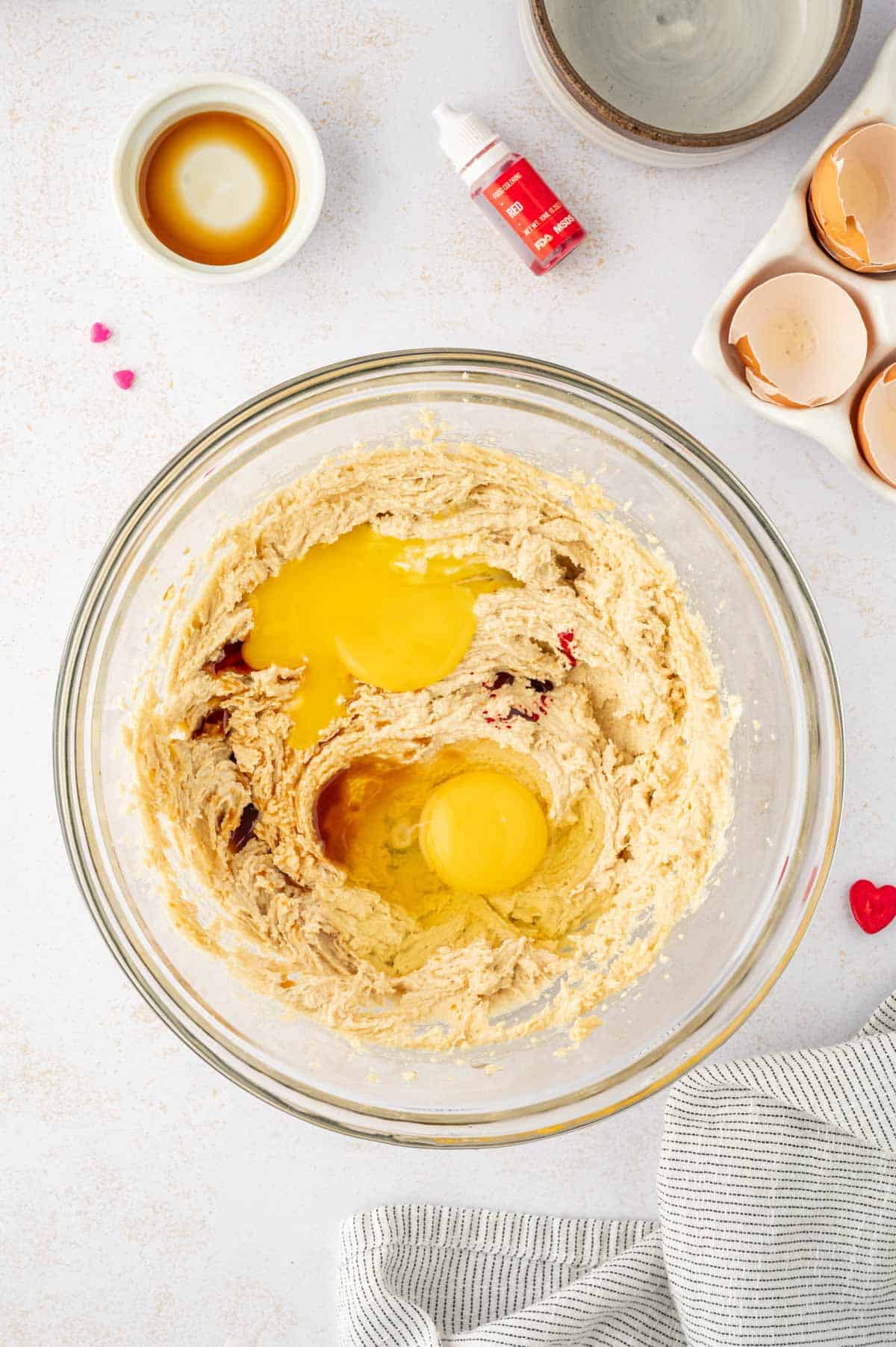 Adding eggs to the cookie cake batter