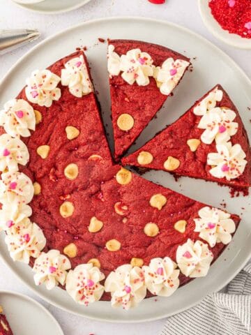 Red velvet cookie cake sliced and kept in a white plate