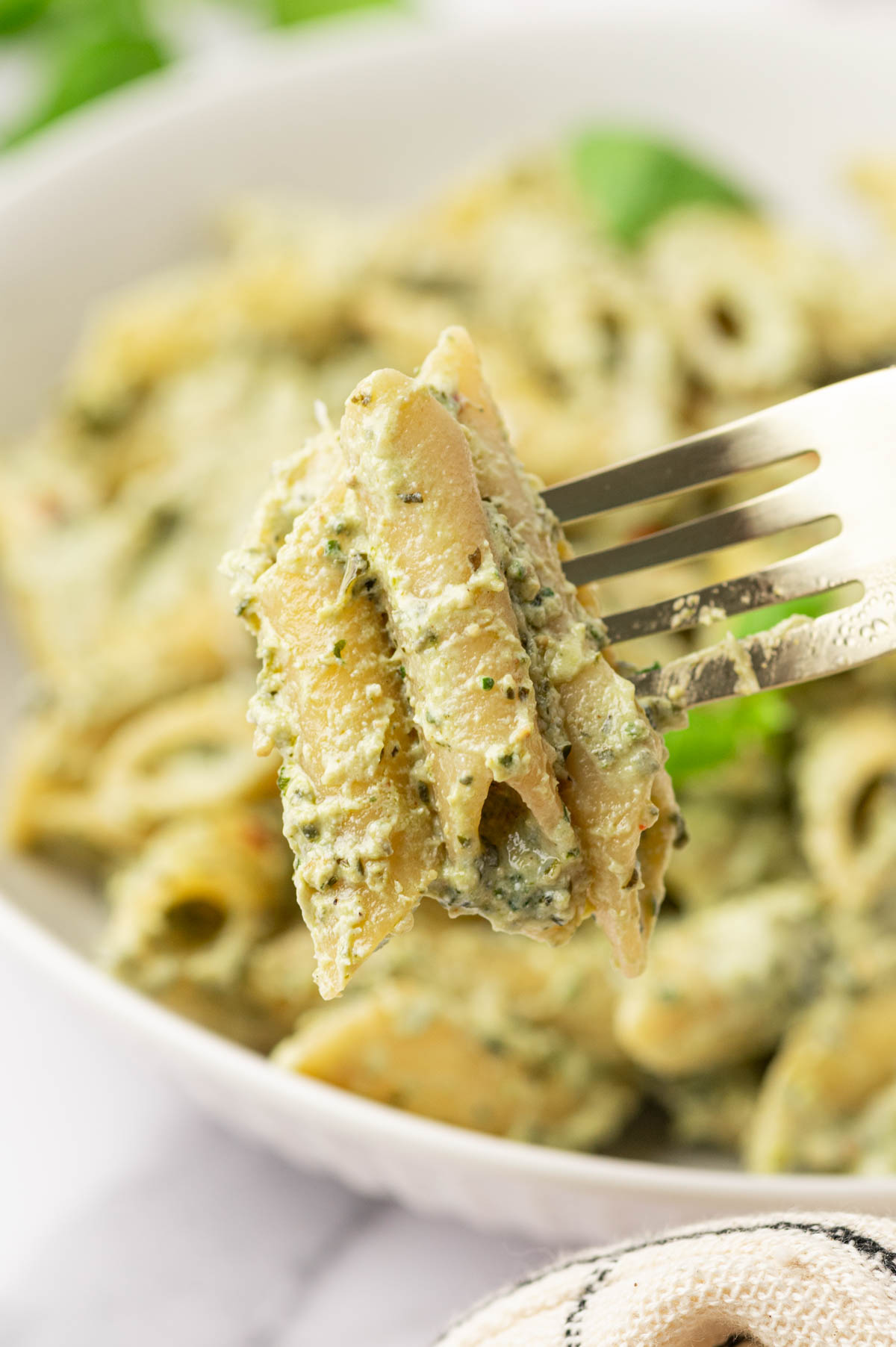 In a fork pesto ricotta pasta