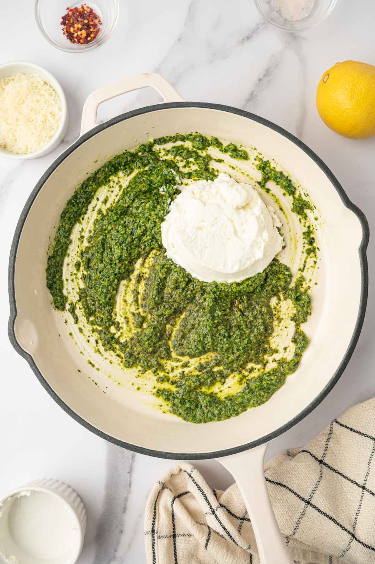 Ricotta cheese and Pesto in a white skillet