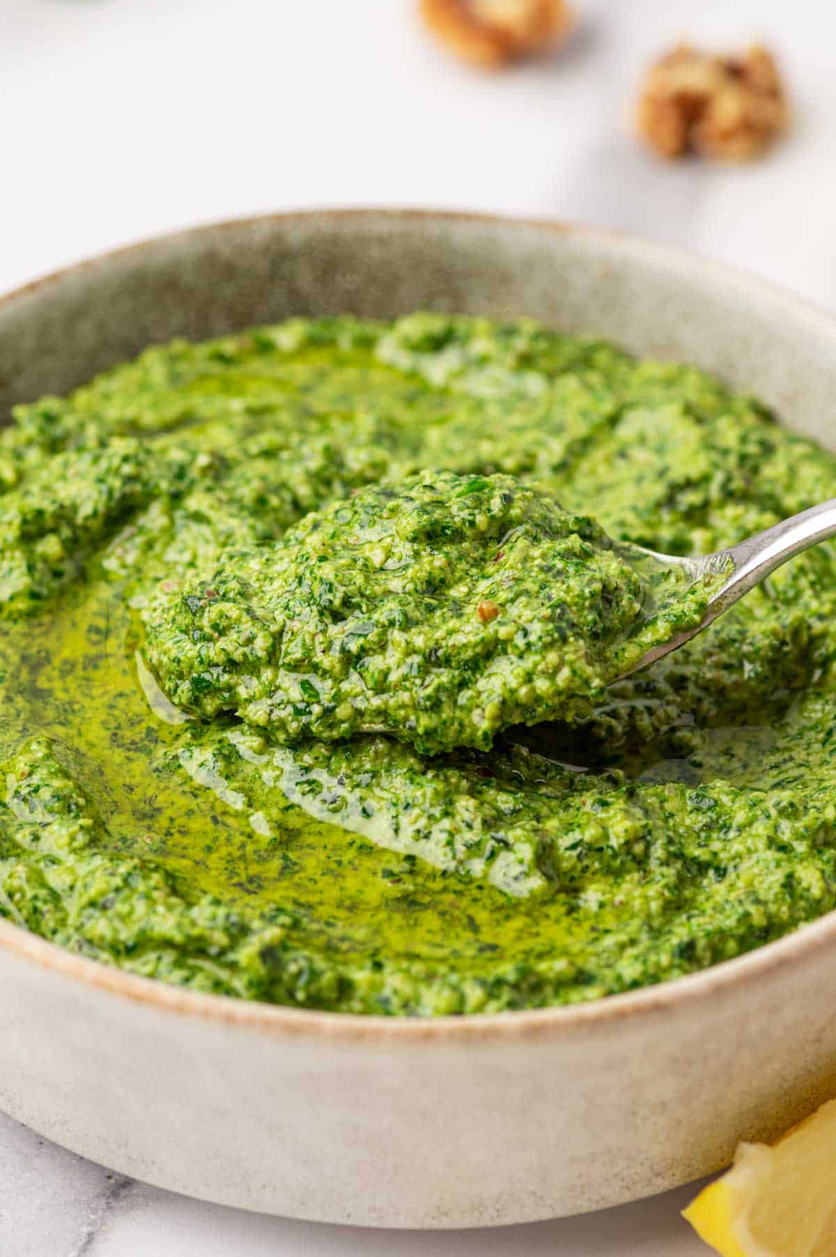 Basil pesto suace without pine nuts in a spoon