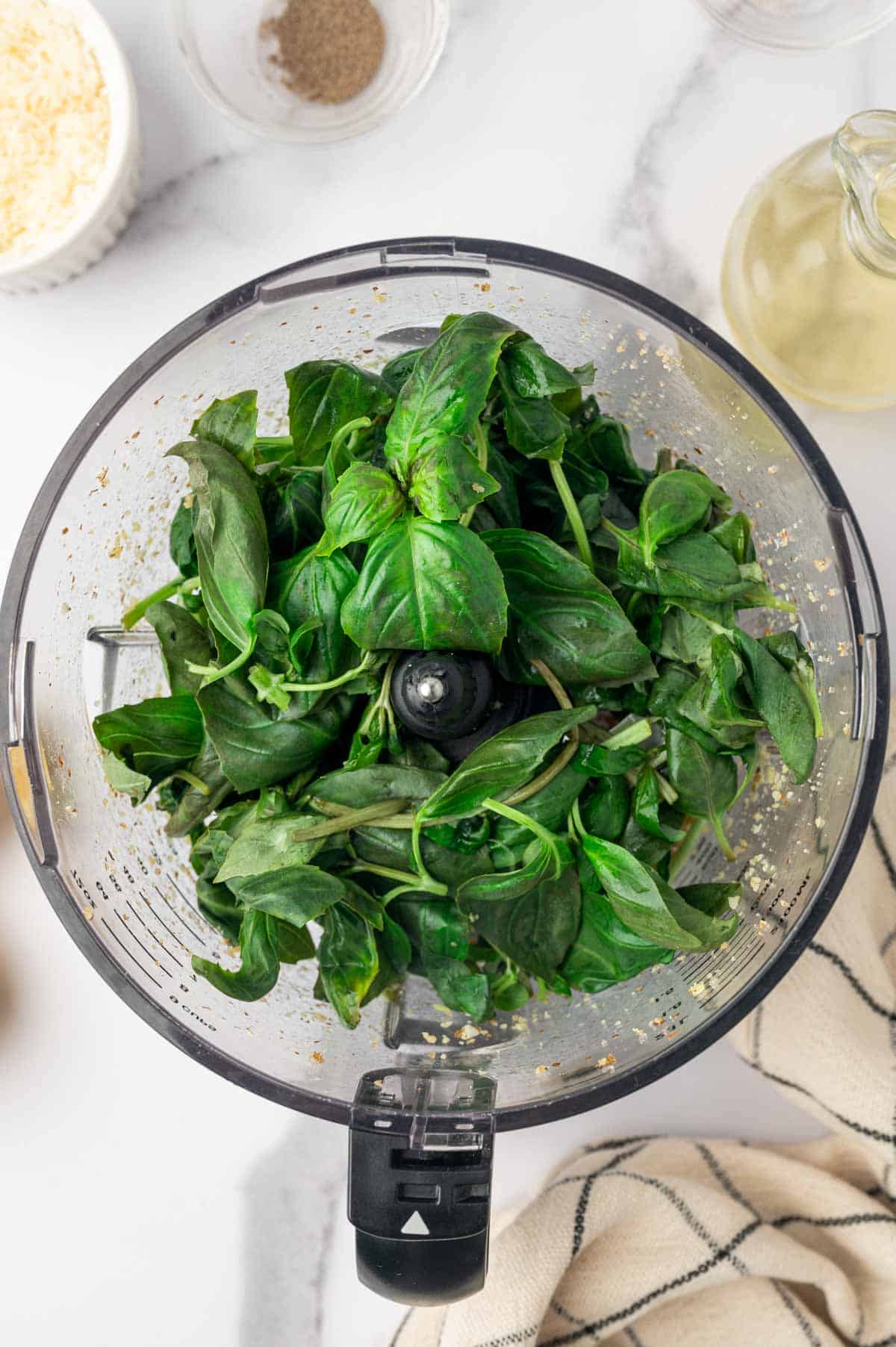 Add the basil leaves to the food processor