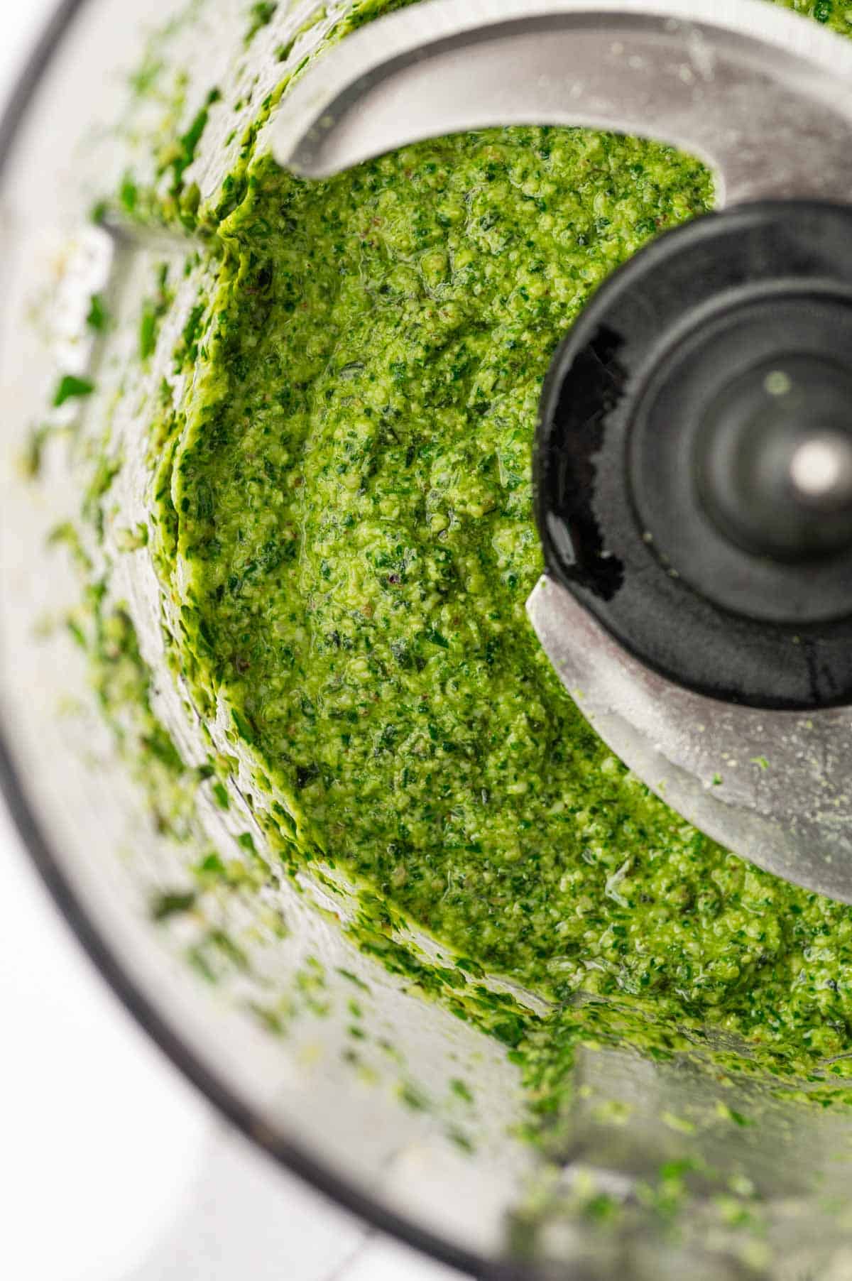 Close up shot for pesto sauce without nuts in a food processor