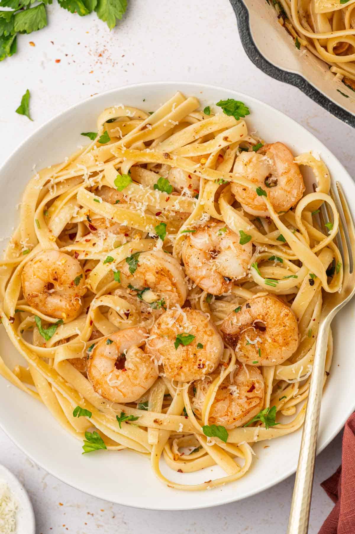 In a bowl shrimp scampi fettuccine with a fork