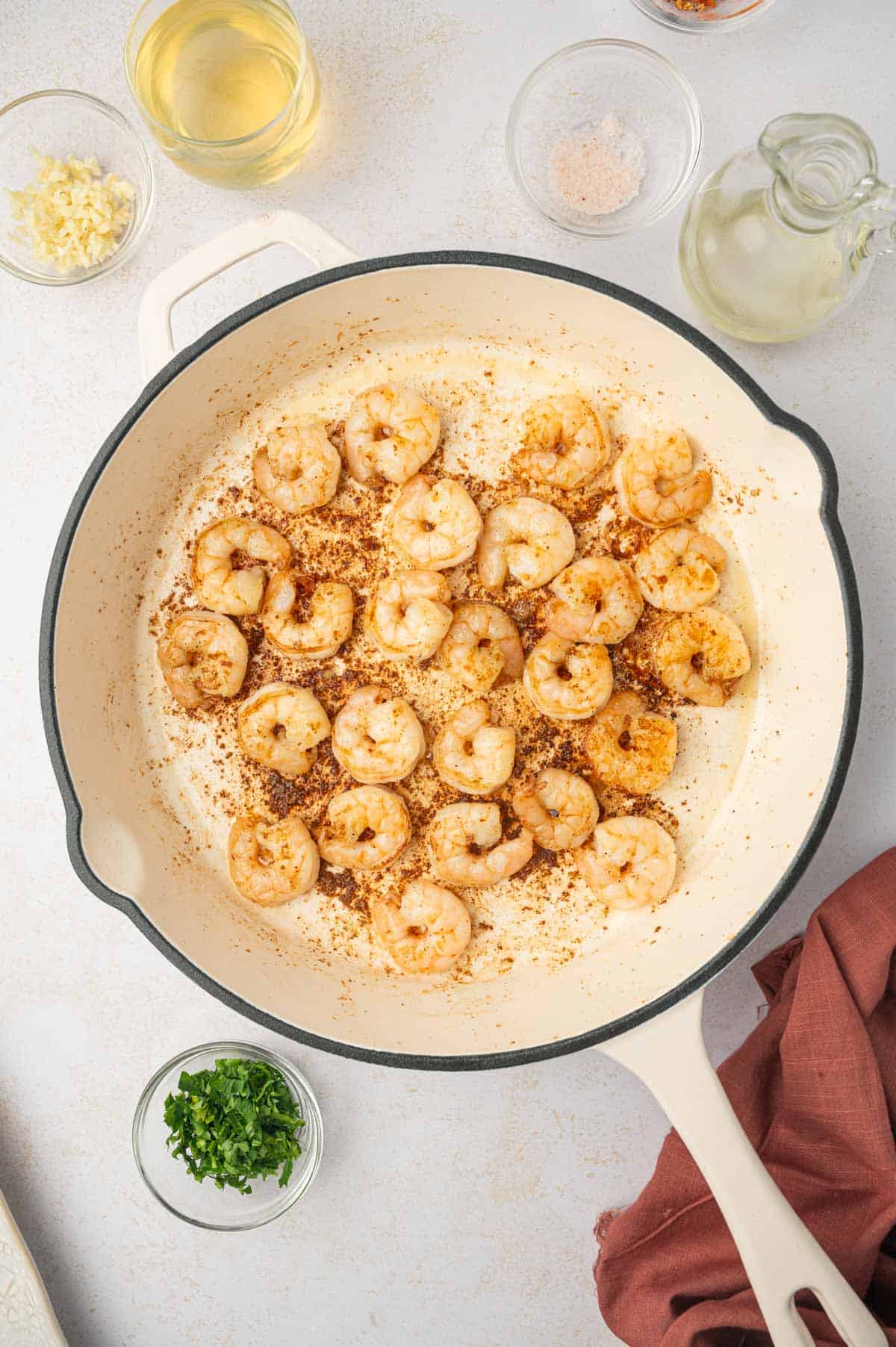 Sautéed shrimp in a skillet.