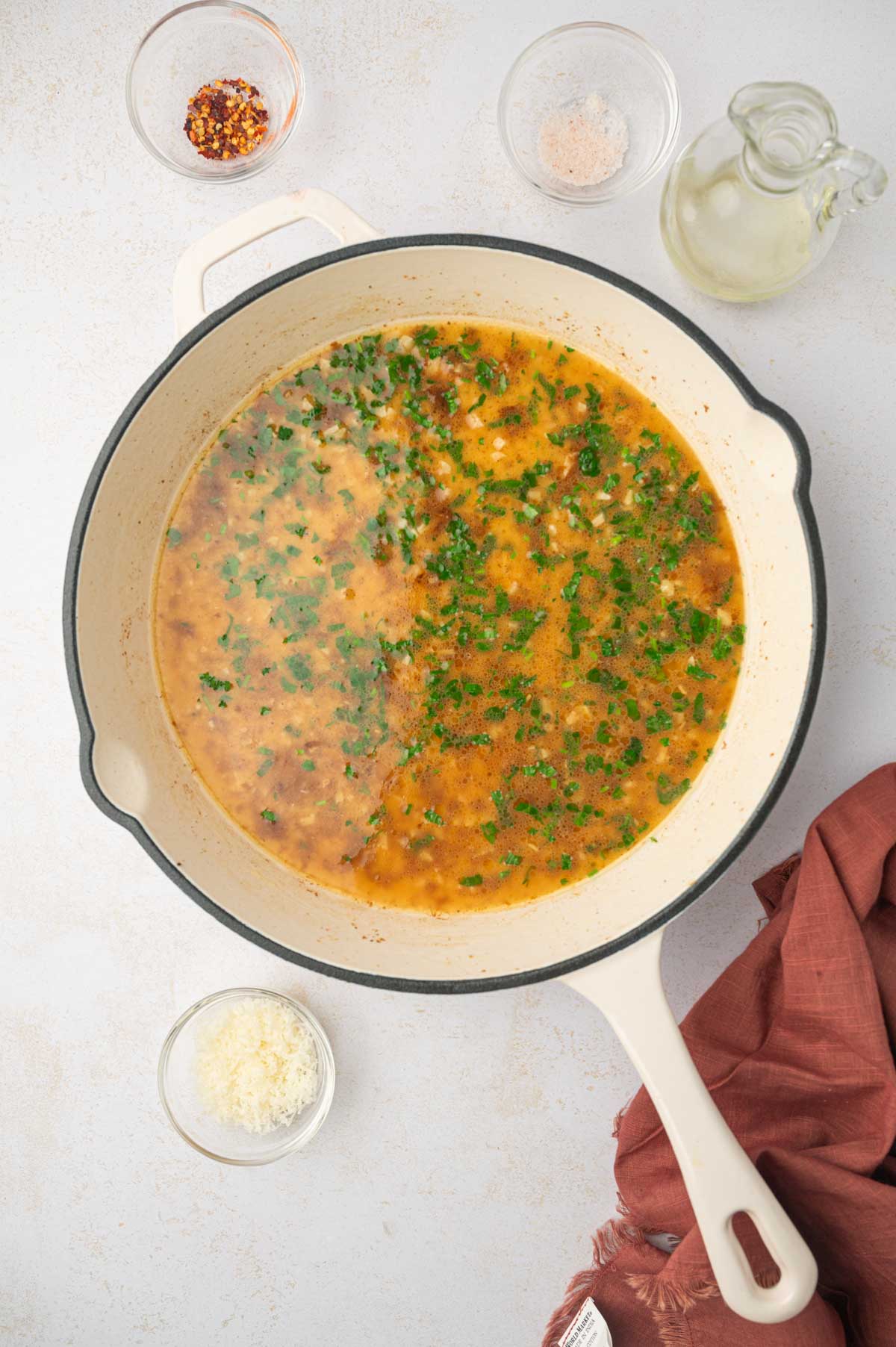 Chicken broth in a skillet for shrimp scampi 