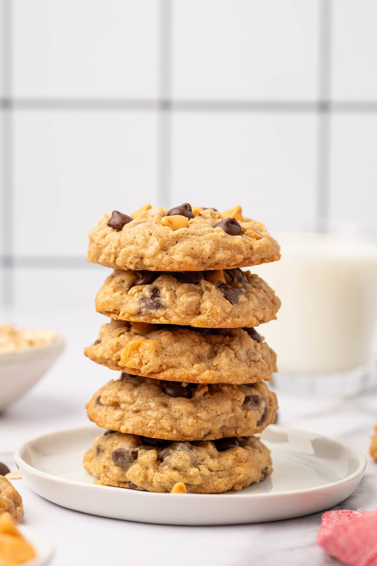 Stacked Oatmeal butterscotch chocolate chip cookies in a white plate