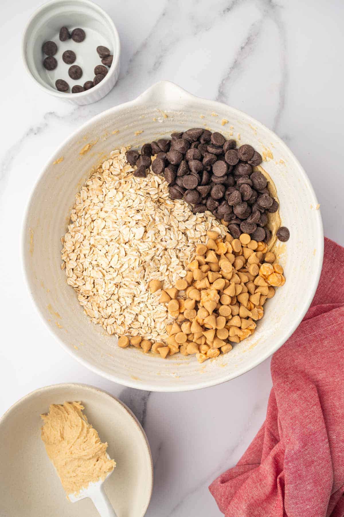 Add oats, chocolate chips and butterscotch chips to the oatmeal cookie dough