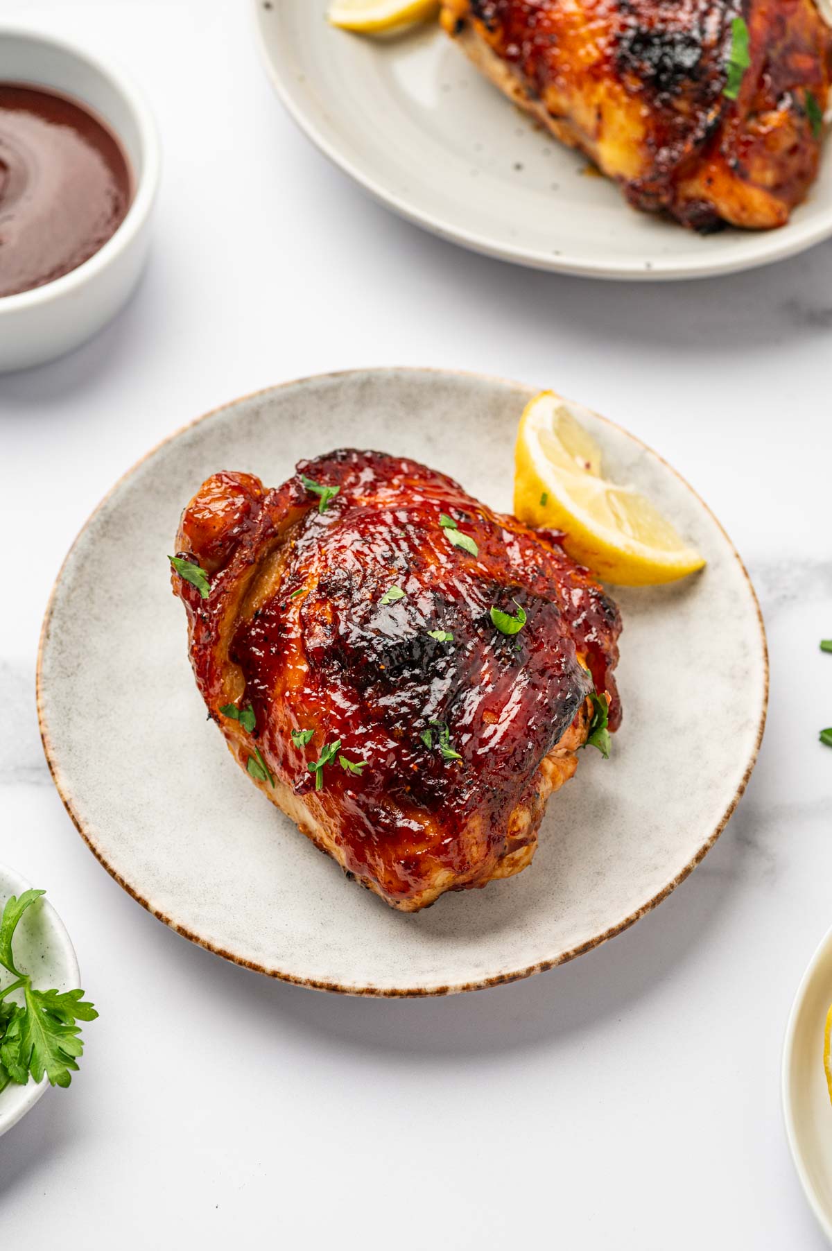 BBQ Air fryer chicken thighs in a white plate.