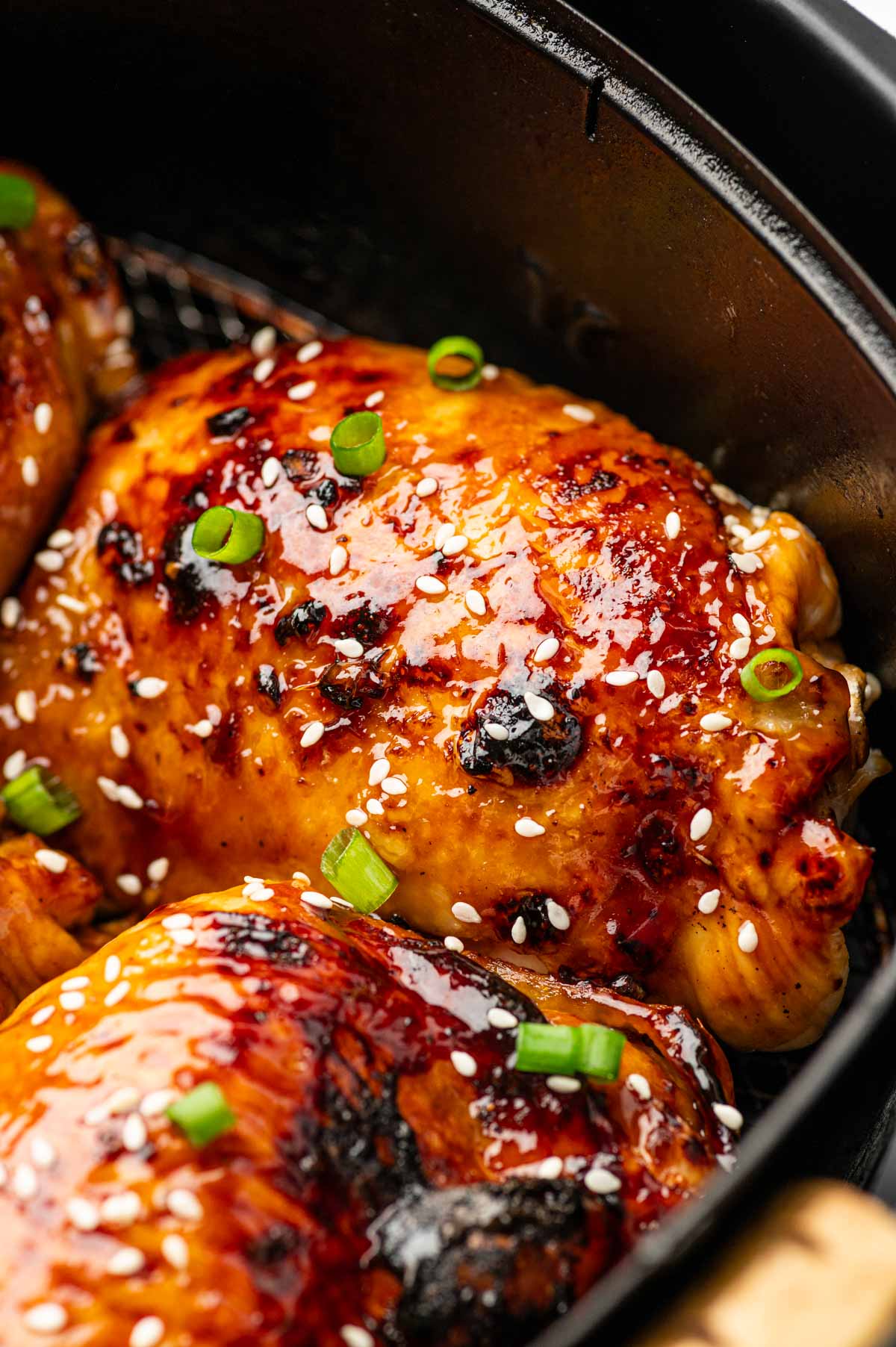 Air Fryer Teriyaki Chicken Thighs in the air fryer basket.