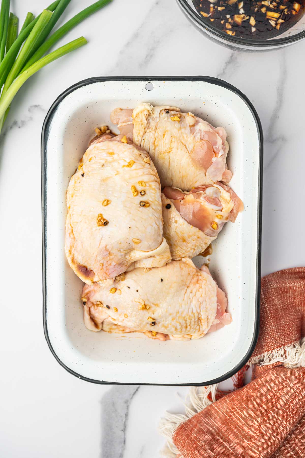 Marinating the chicken thighs in teriyaki sauce.