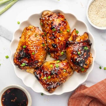 Crispy Air Fryer Teriyaki Chicken Thighs with Sesame Seeds and Green Onions.