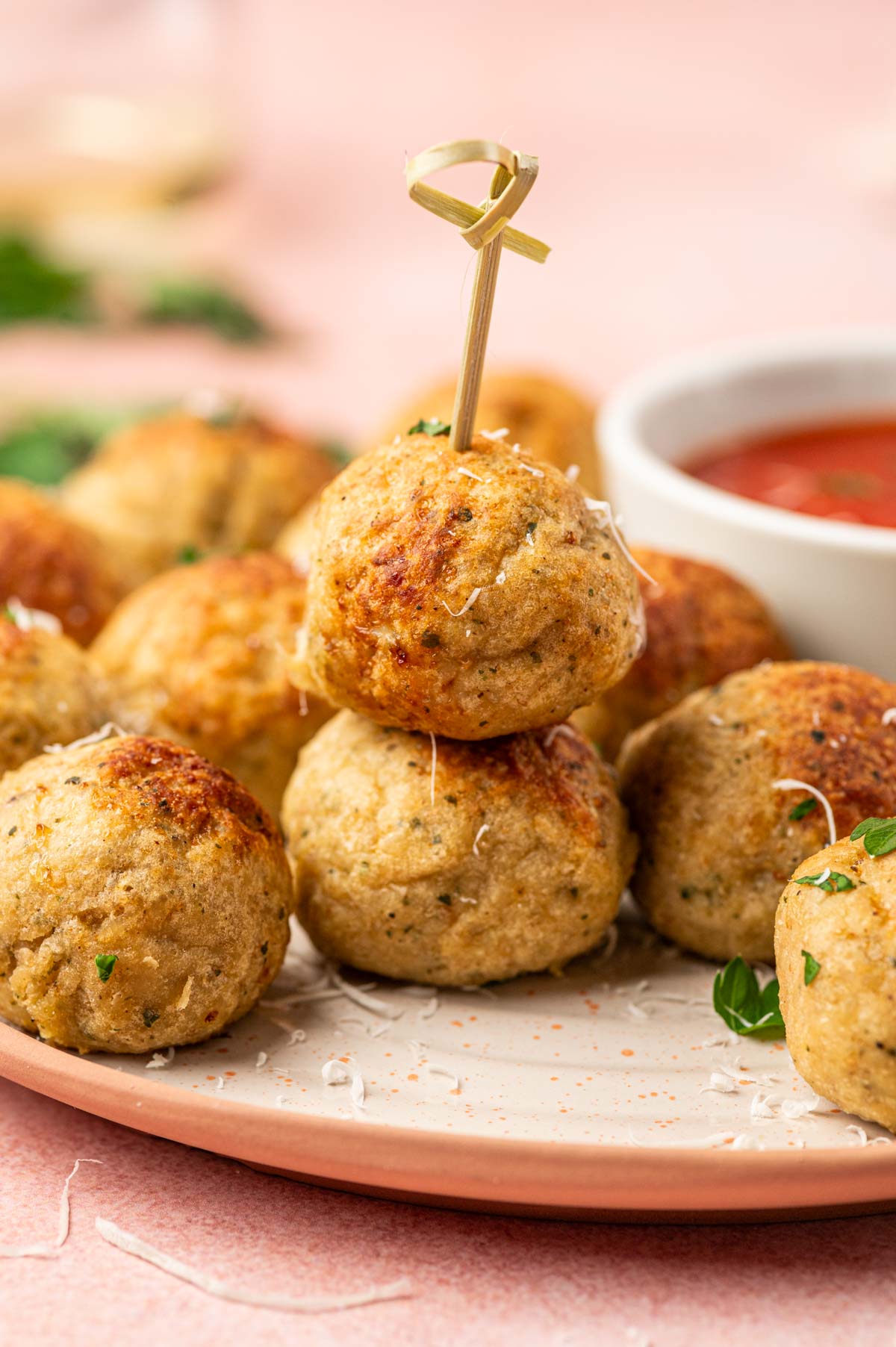 Stacked meatballs in one above the another in a white plate.