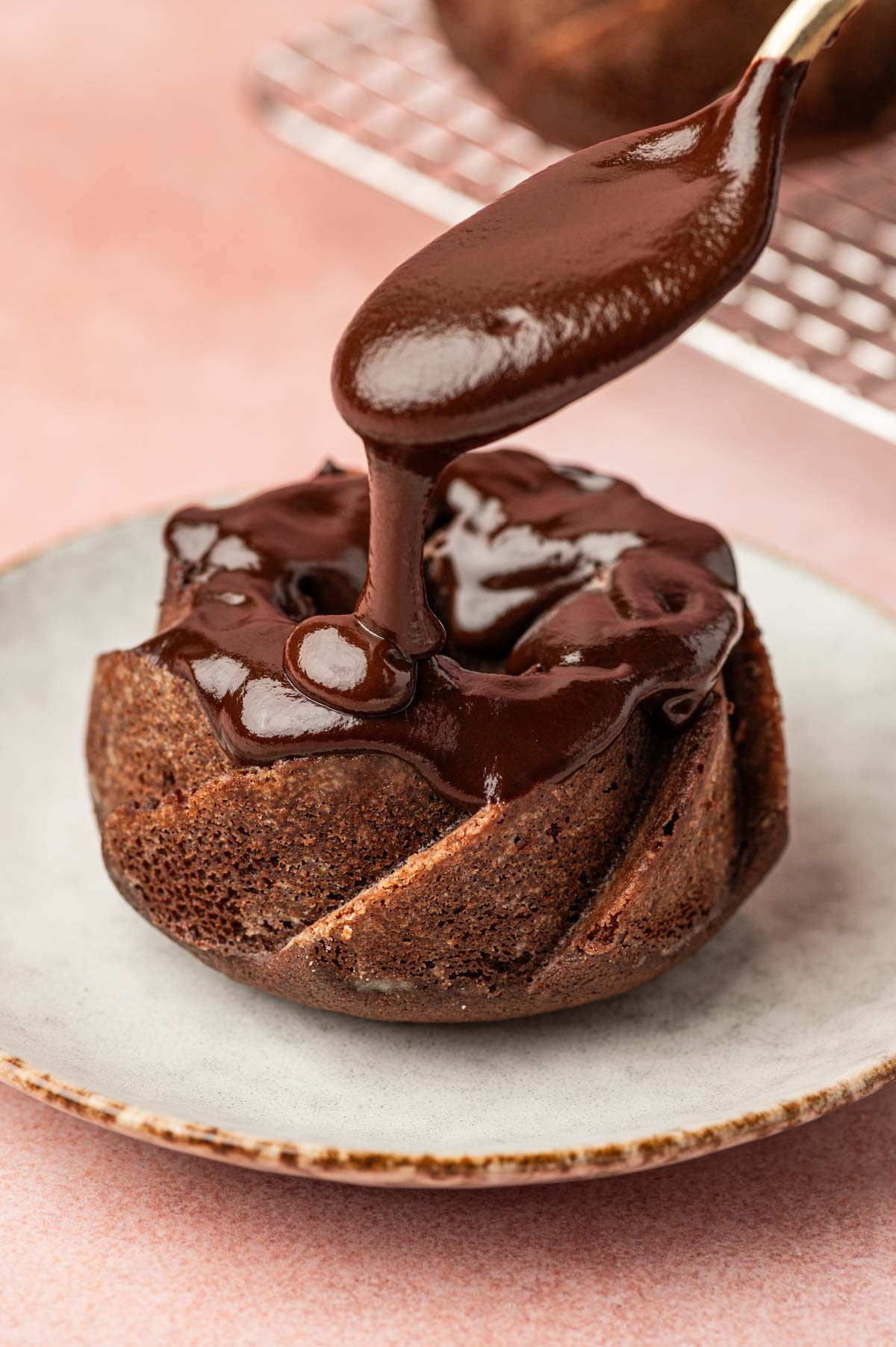 Dark chocolate ganache drizzled over the mini chocolate bundt cakes.