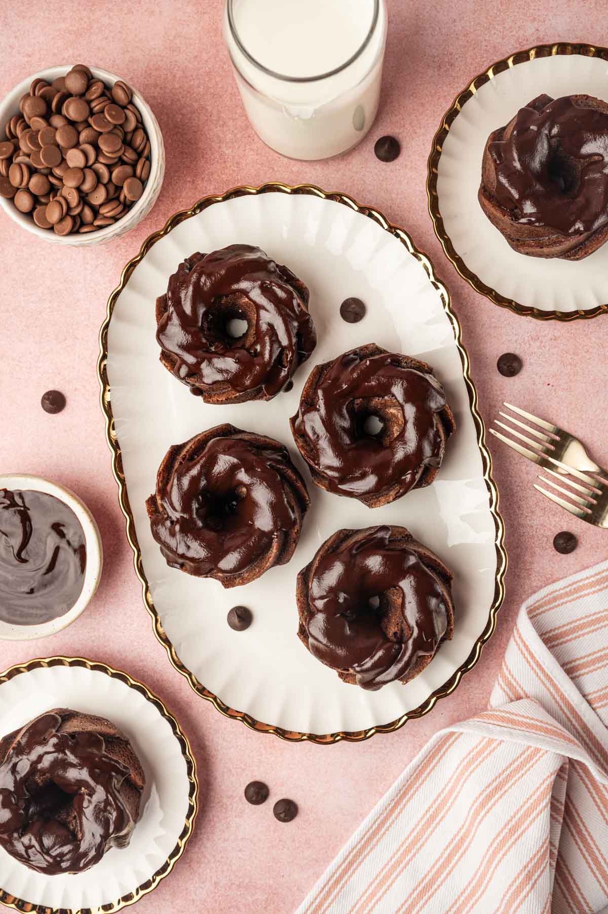 Flatl lay image of chocolate mini Bundt cake with chococlate chips, milk in the sides.