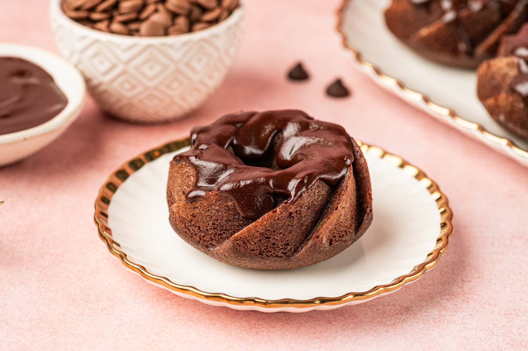 Mini chocolate bundt cake with chocolate drizzle on it.