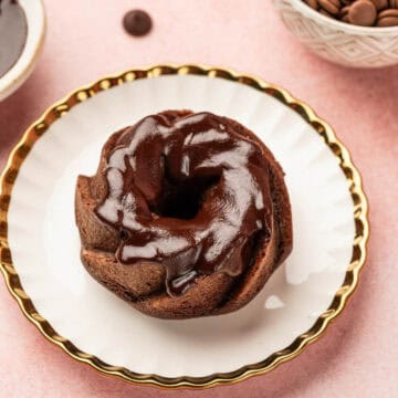 Close up shot of chocolate mini bundt cake with chocolate drizzle on it.