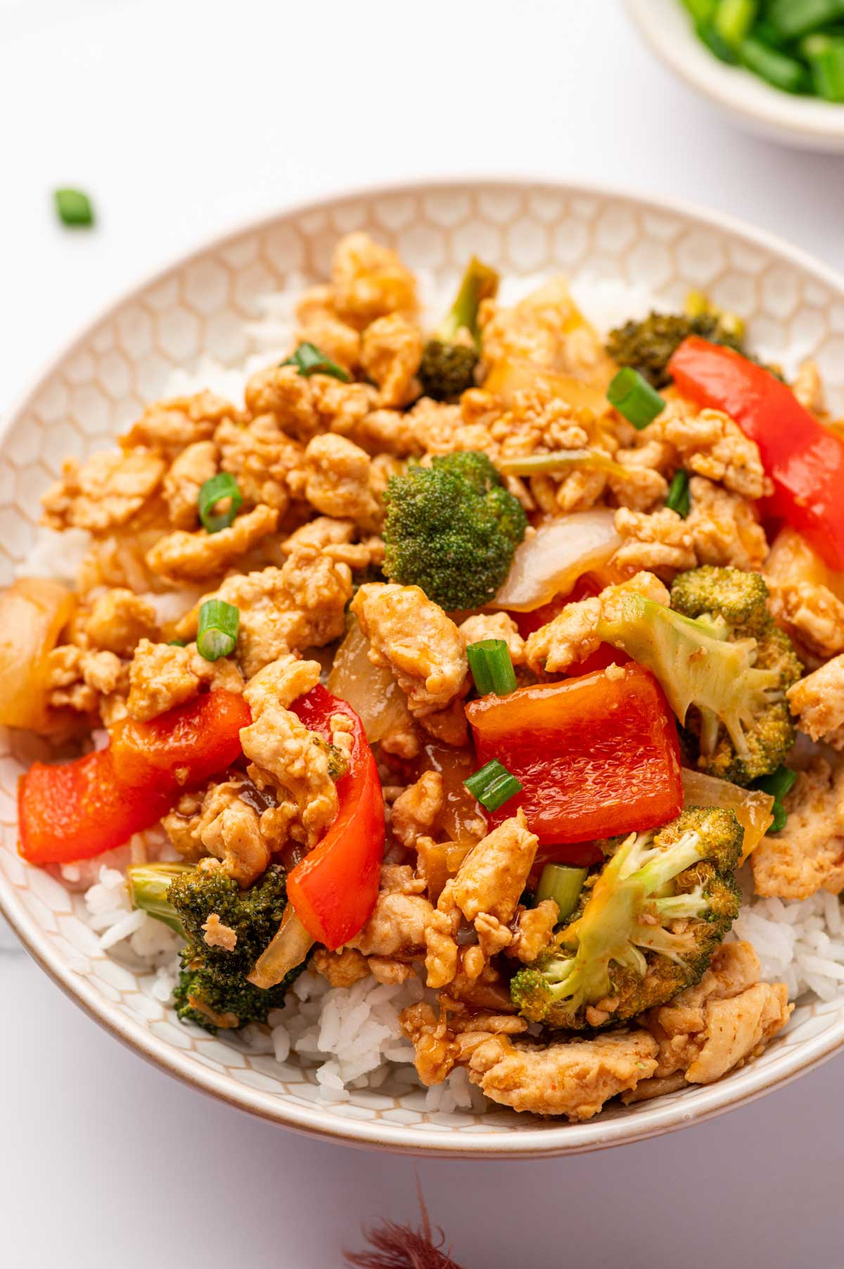 Asian chicken stry fry recipe in a white bowl.