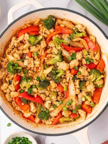 Healthy ground chicken stir fry in a skillet.