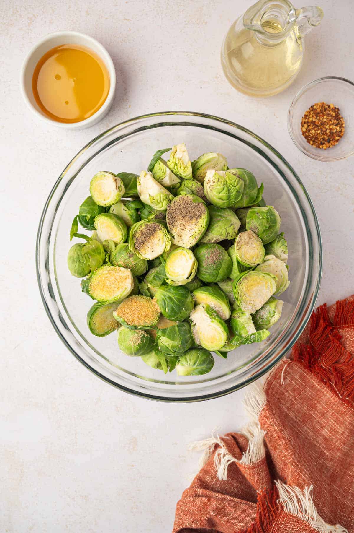 Seasonings on top of the brussels sprouts 