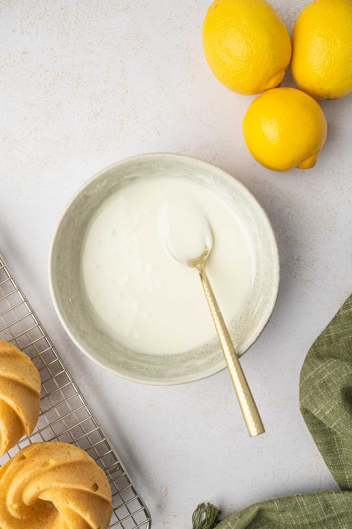 lemon icing prepared in a bowl for mini lemon bundt cakes.