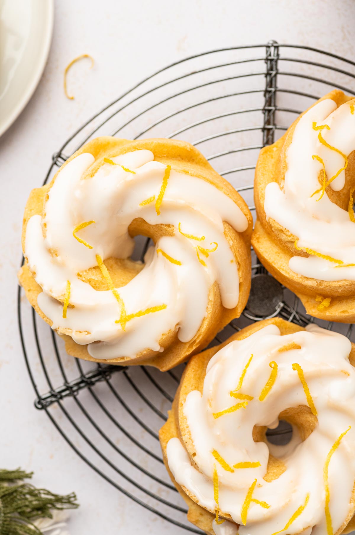 Lemon mini bundt cake in a cooling rack.