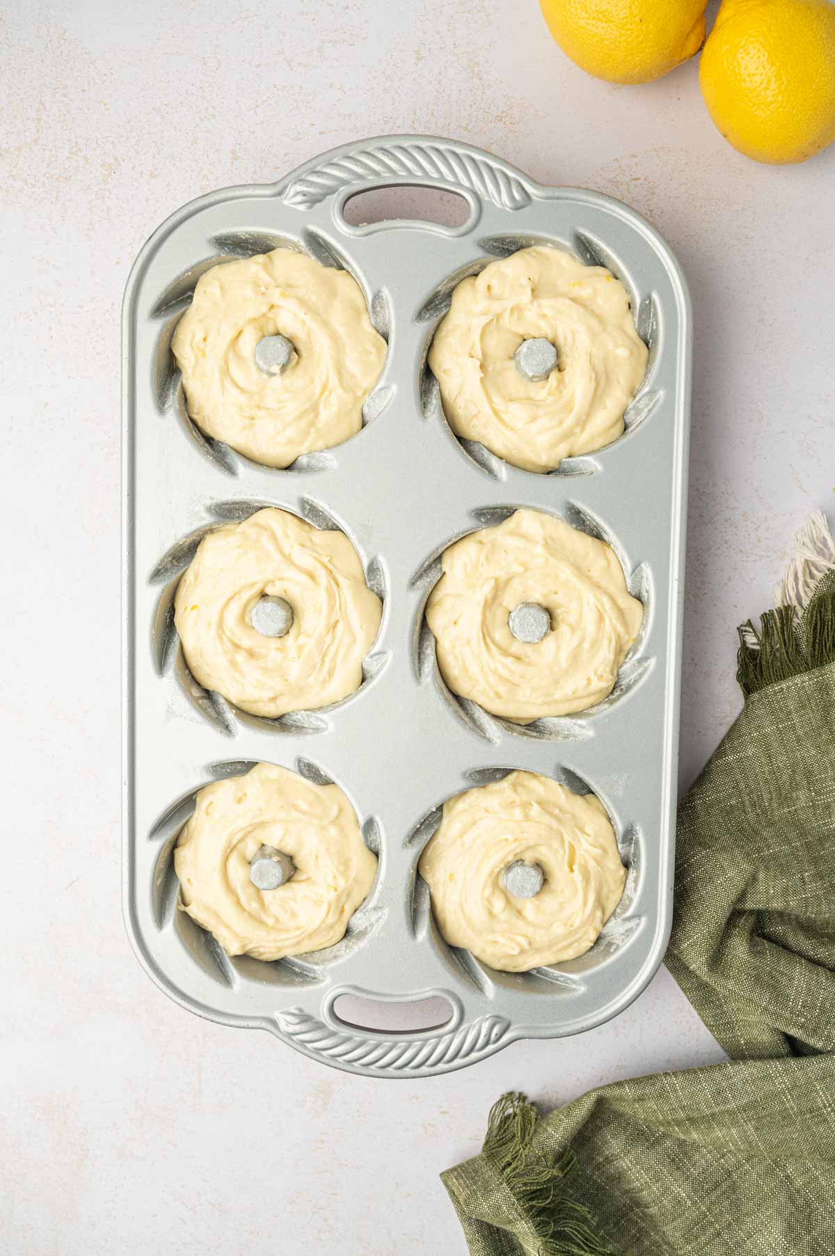 Mini lemon bundt cake batter filled in the mini bundt cake pan.