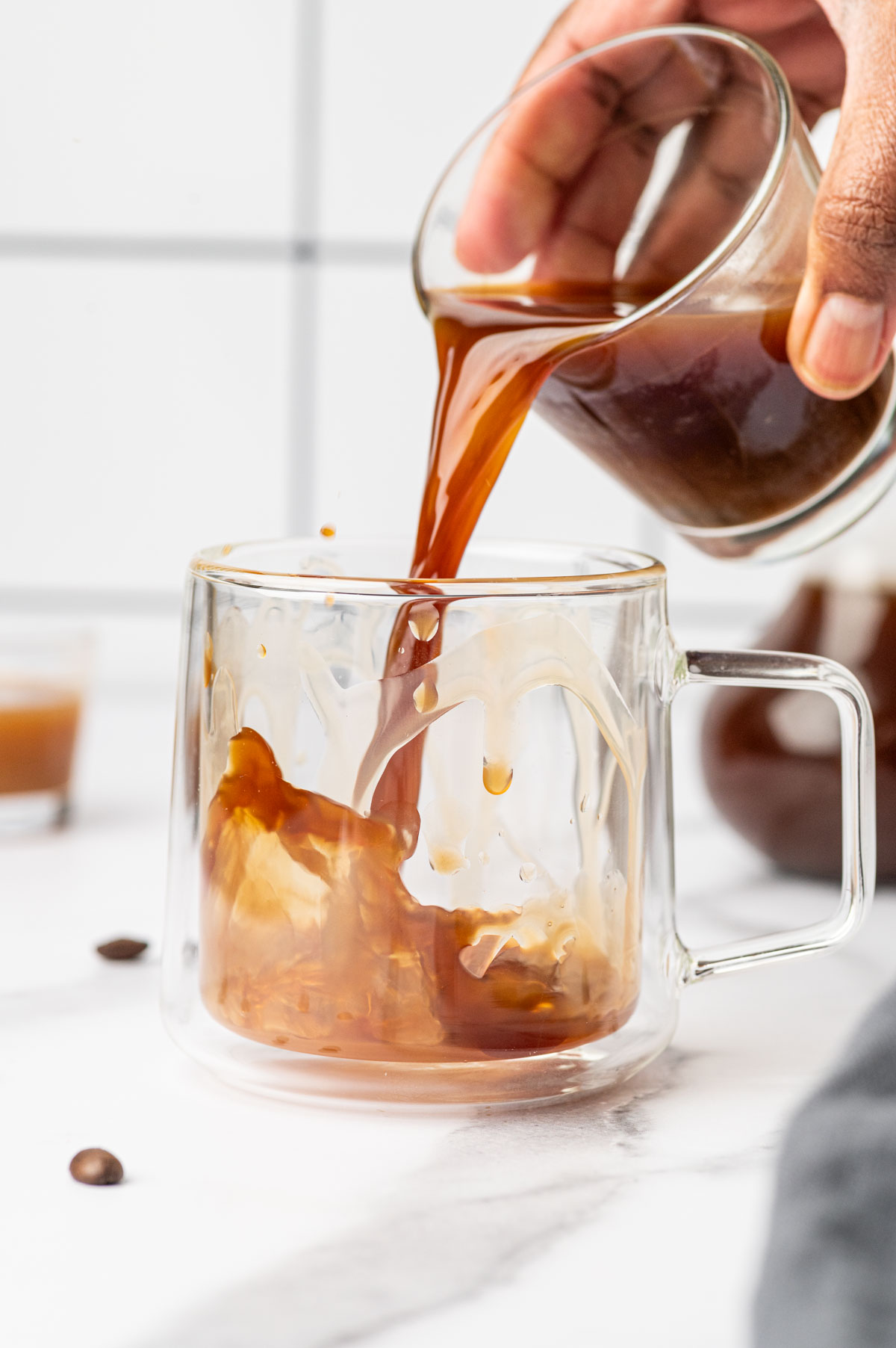 Freshly brewed coffee pour into the caramel drizzled glass.