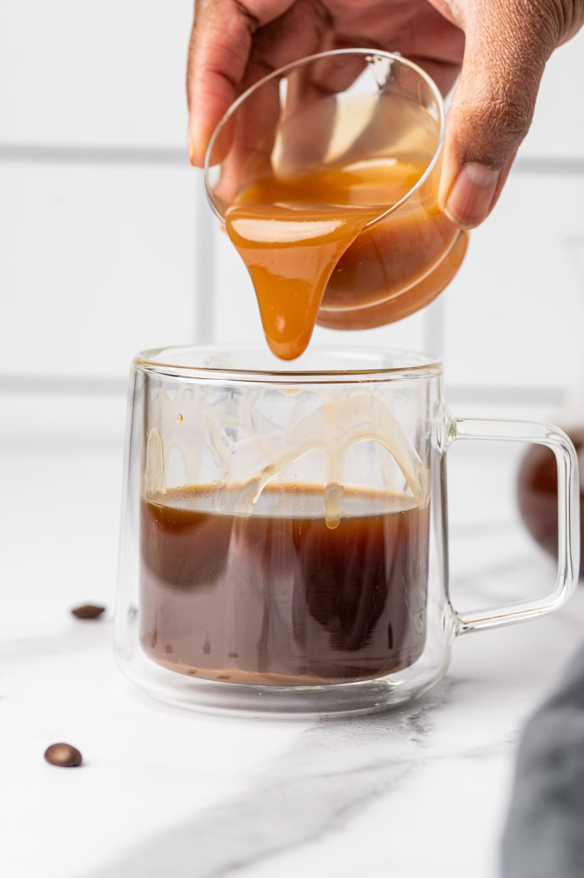 Caramel syrup being added to the salted caramel latte.