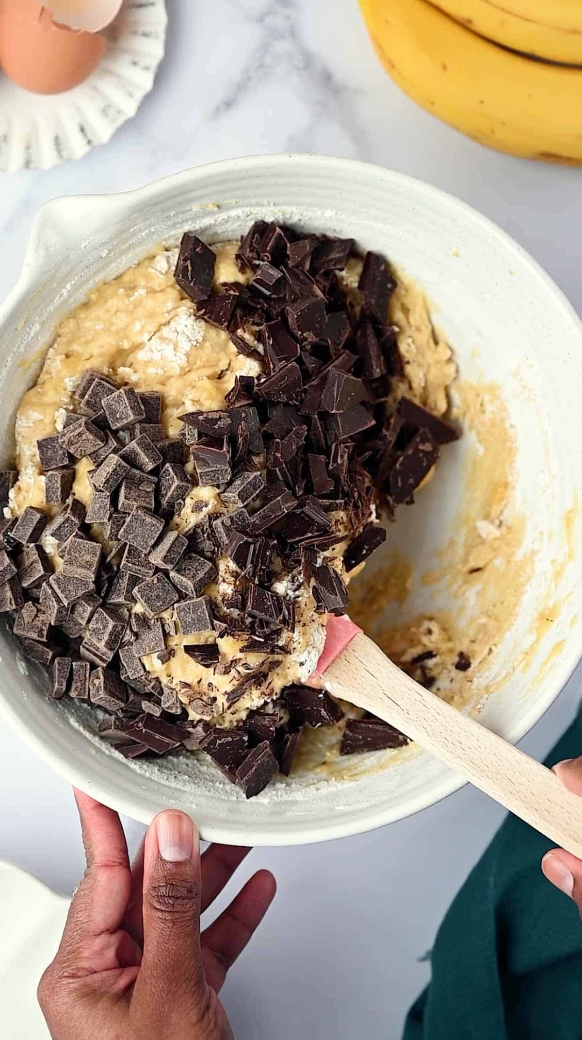 Chocolate chunks added to the muffin batter.