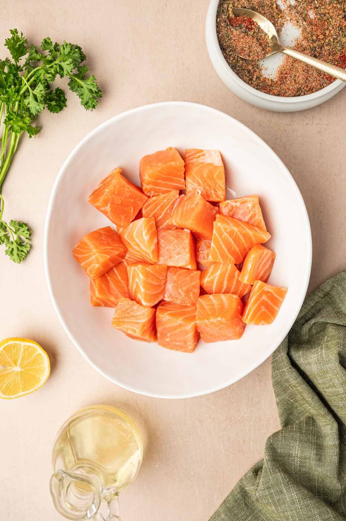 Salmon cubes in a white bowl.