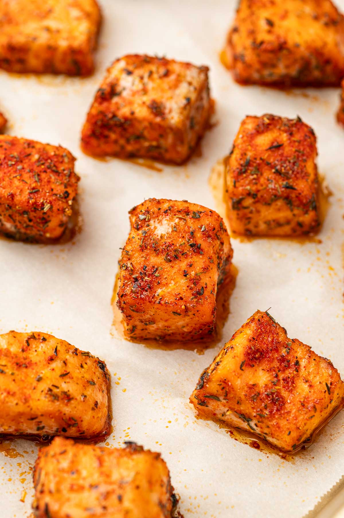 Baked blackened salmon bites in a baking tray.