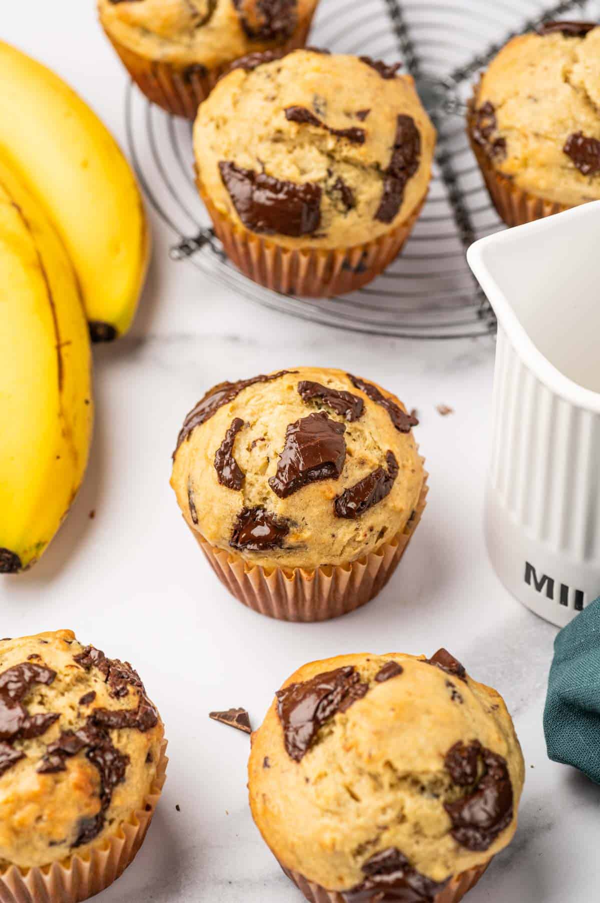 Banana chocolate chunks muffins placed beautifully, banana placed in the side.