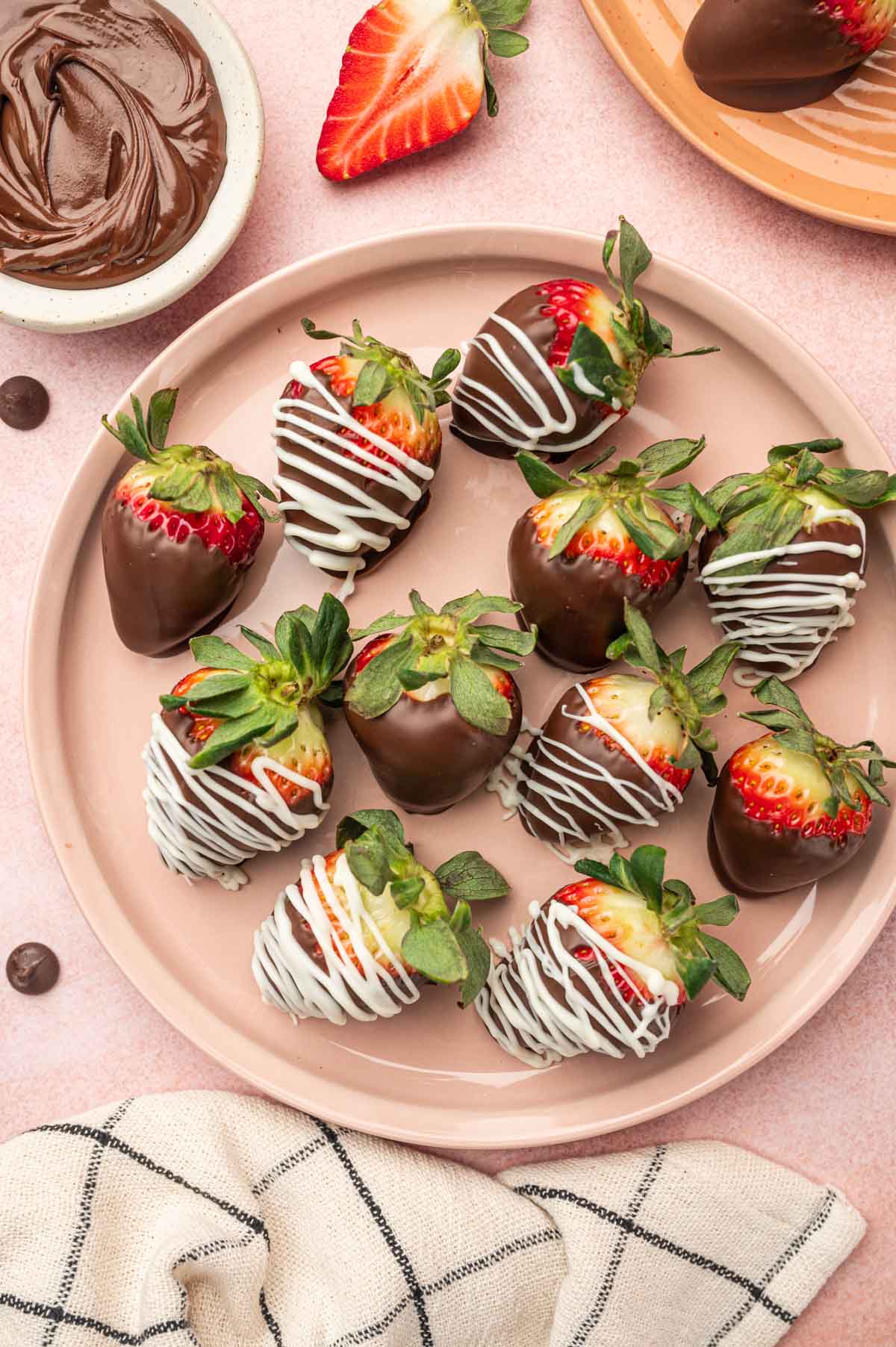 Strawberry covered chocolate and nutella dessert placed in a pink plate.