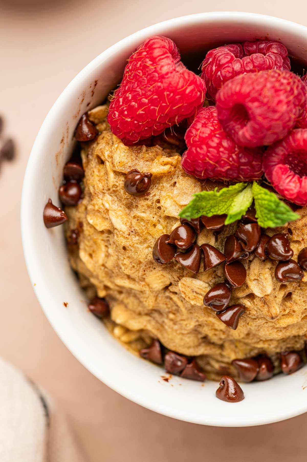 CLose up shot of oatmeal mug cake in a white mug.