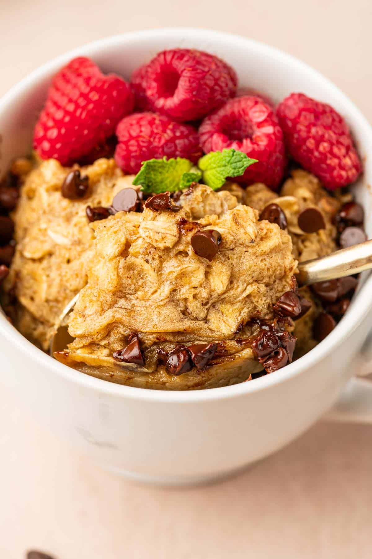 Spoon getting scoop of oatmeal mug cake.