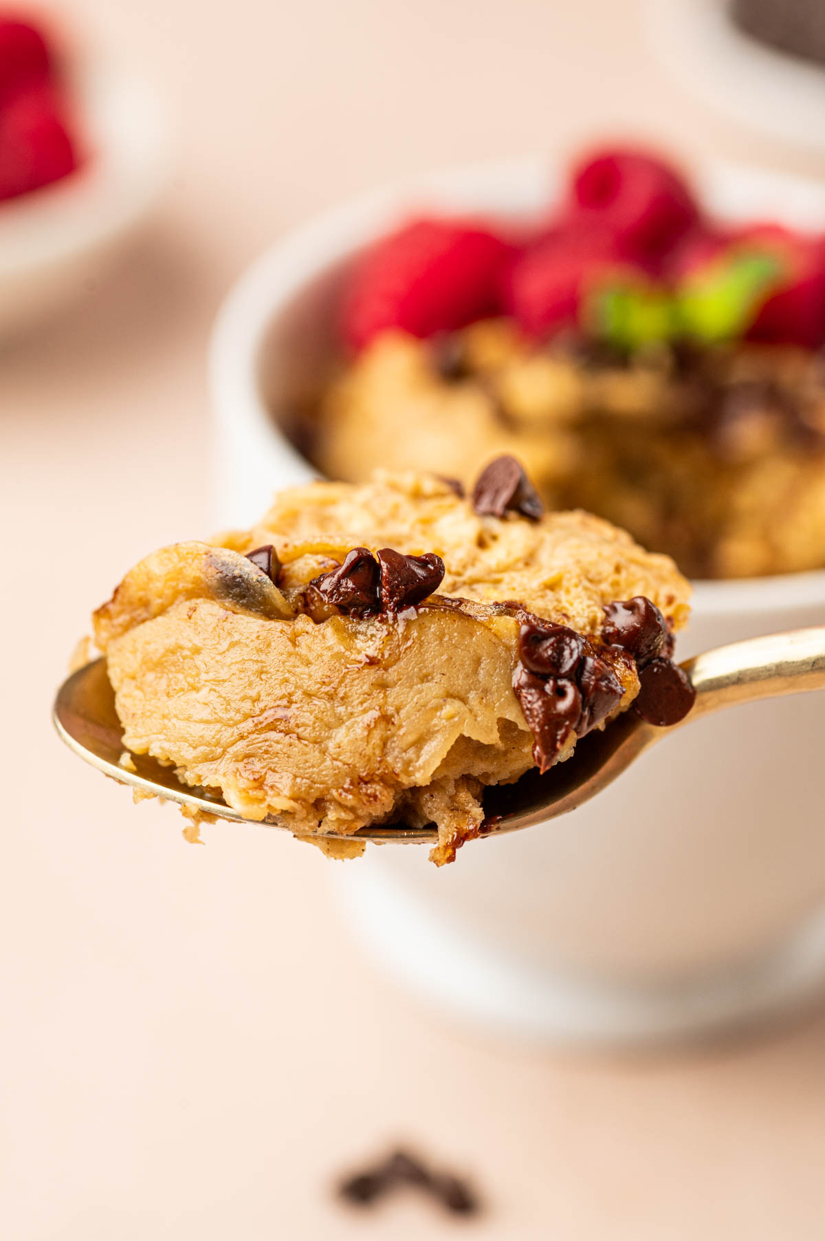 Oatmeal scooped from the mug cake in a spoon.