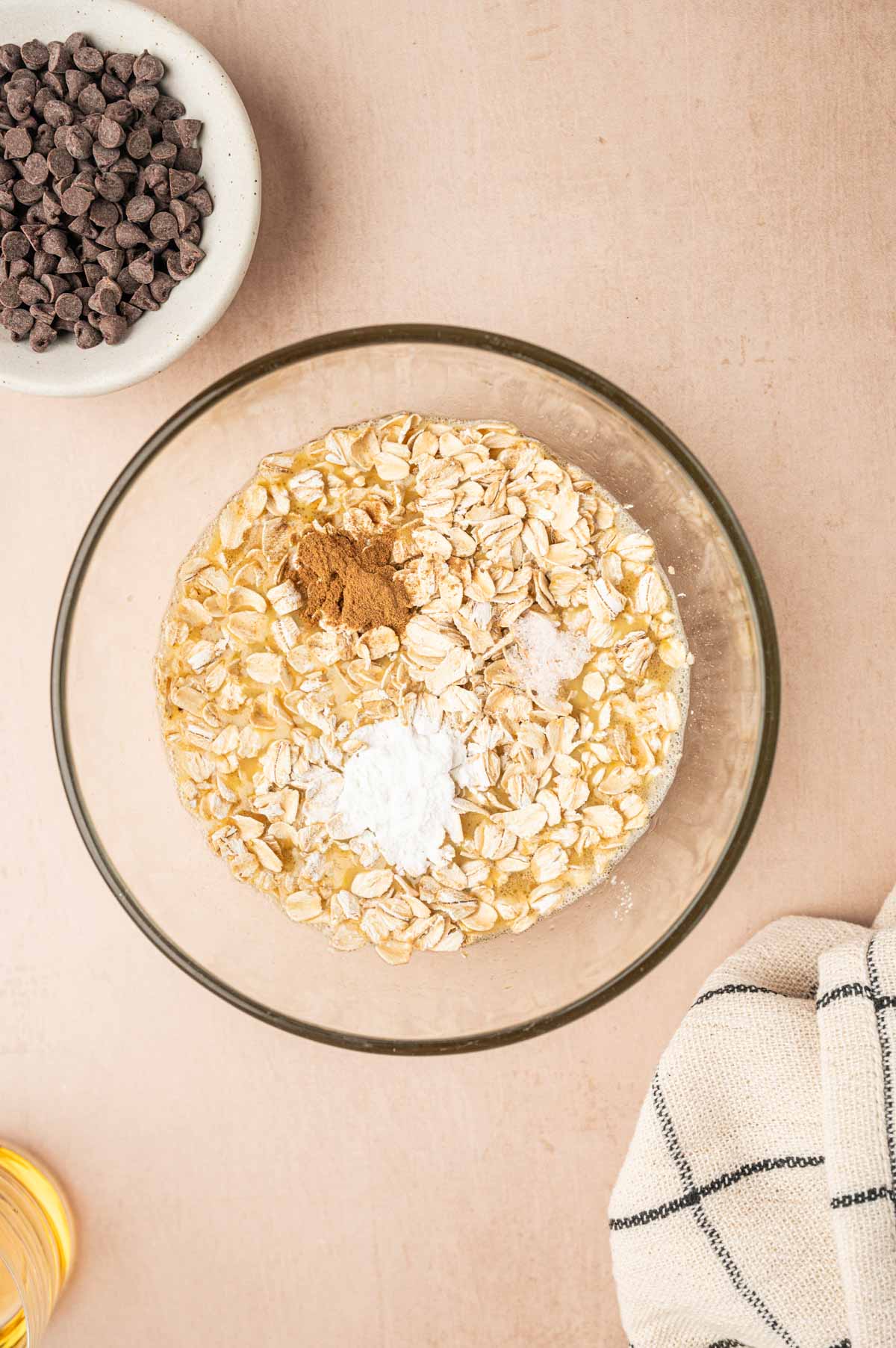 Oats, baking powder and cinnamon added to the bowl.