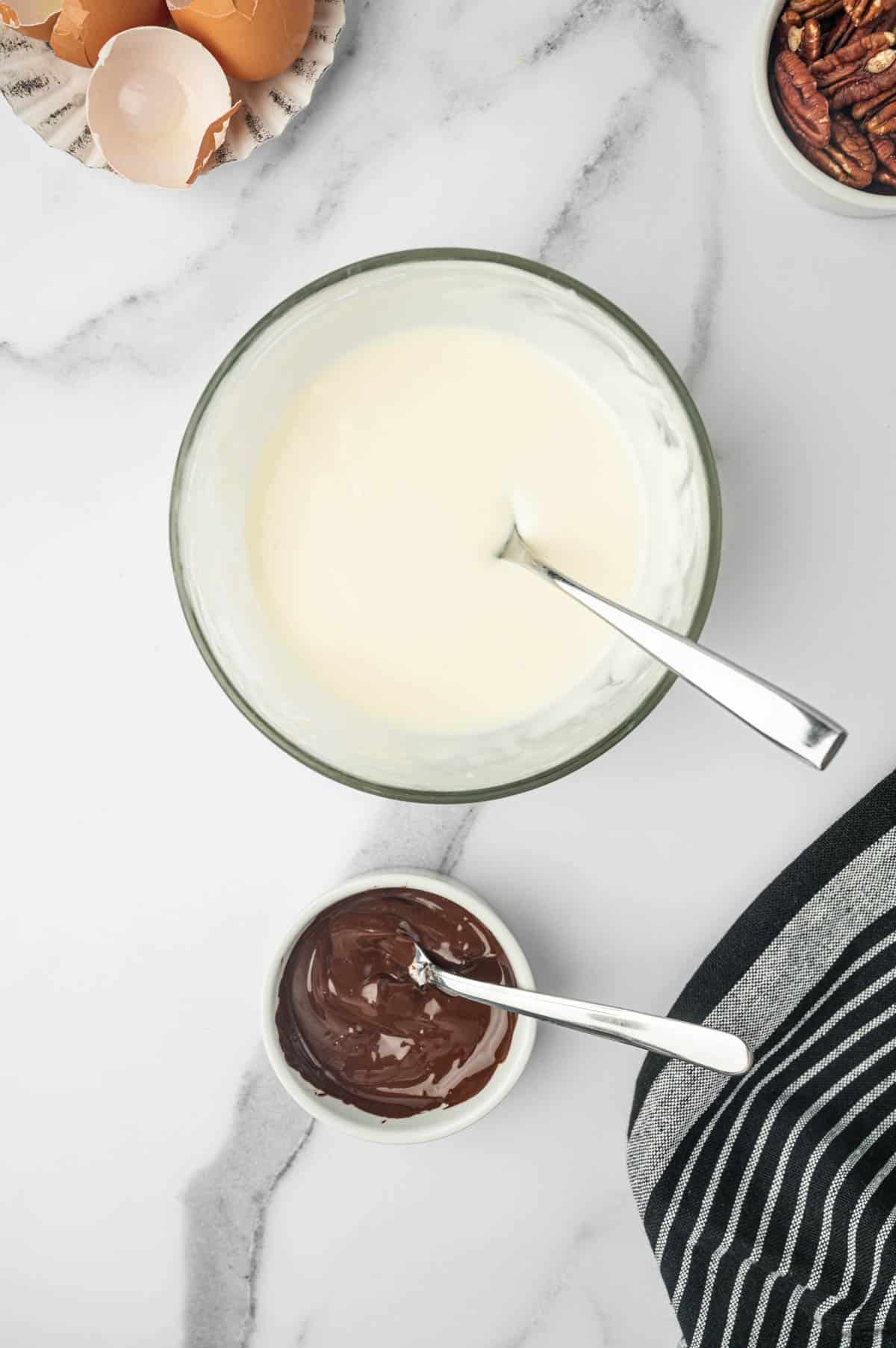 Cream cheese glaze and chocolate ganache in bowls.