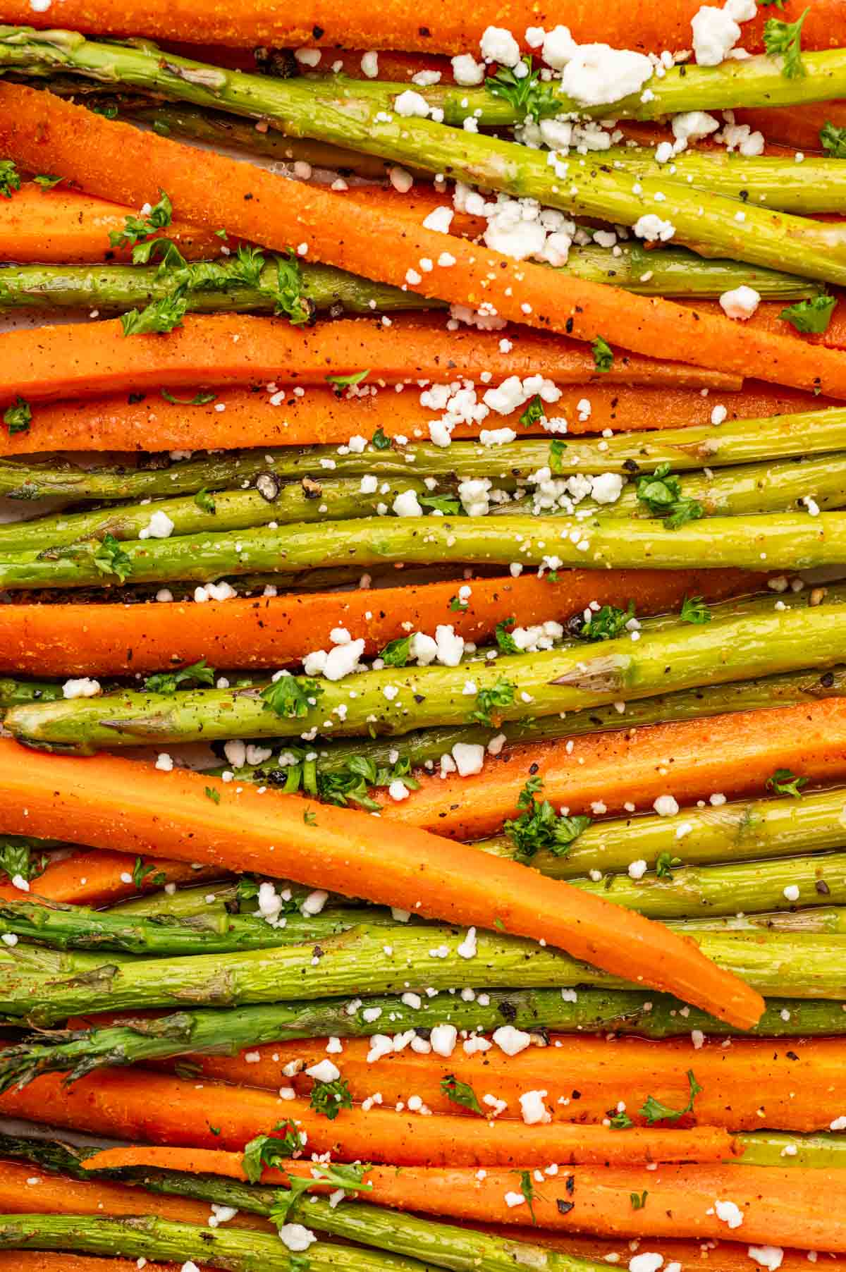 CLose up shot of showing texture of simple roasted carrots and asparagus recipe.