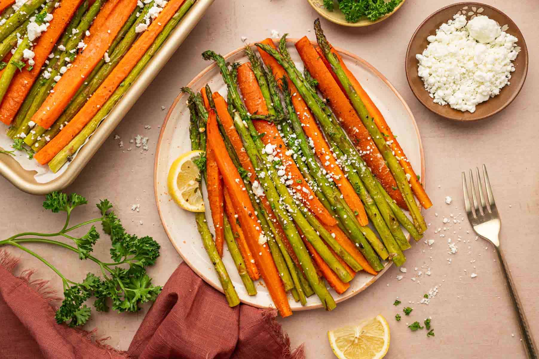 Horizontal shot of roasted carrots and asparagus recipe served in a plate.