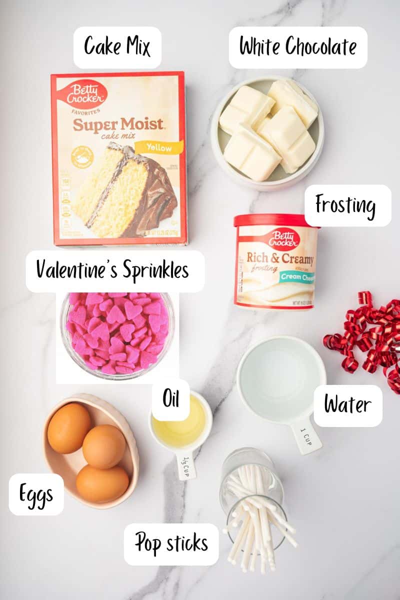 Ingredients laid out for Valentine's Day cake pop recipe in a marble table.