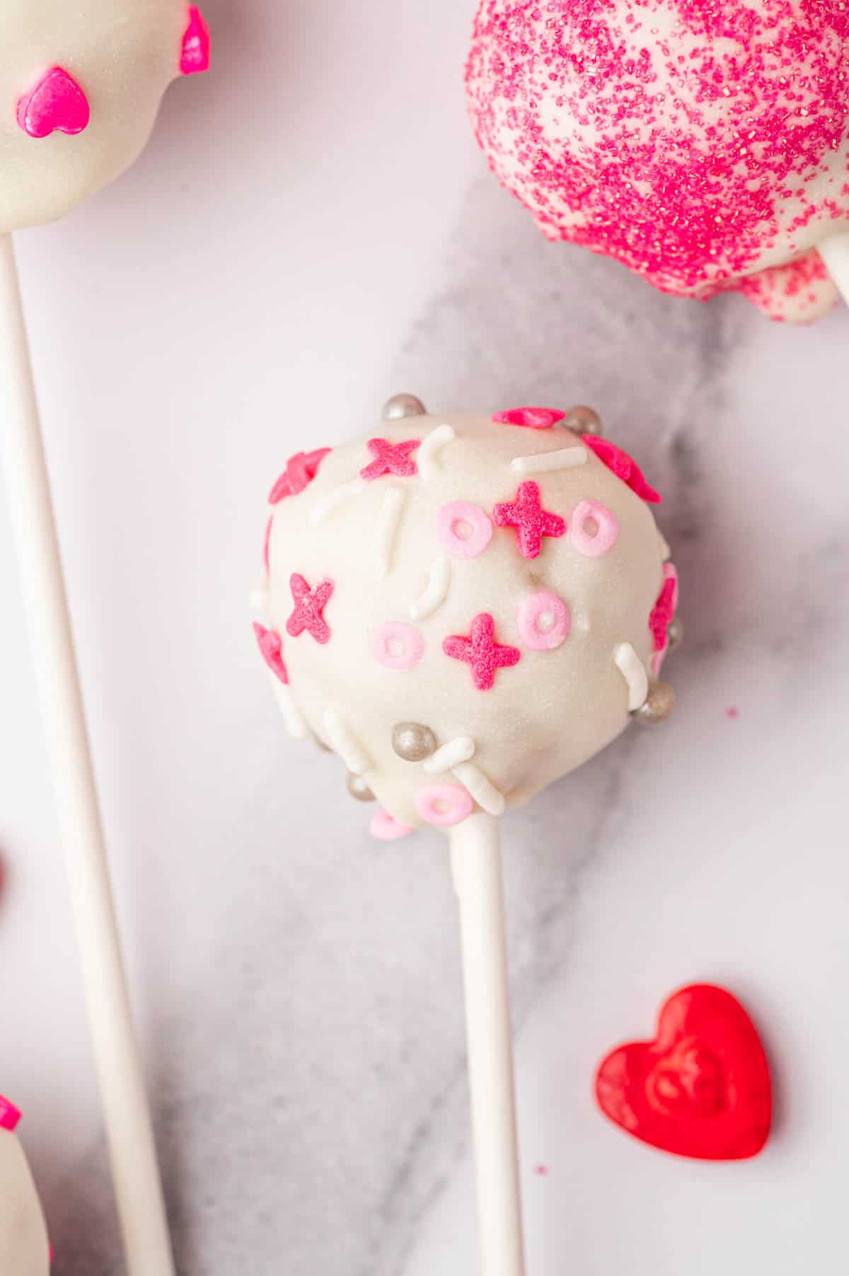 Homemade valentines day cake pops beautifully decorated with sprinkles.