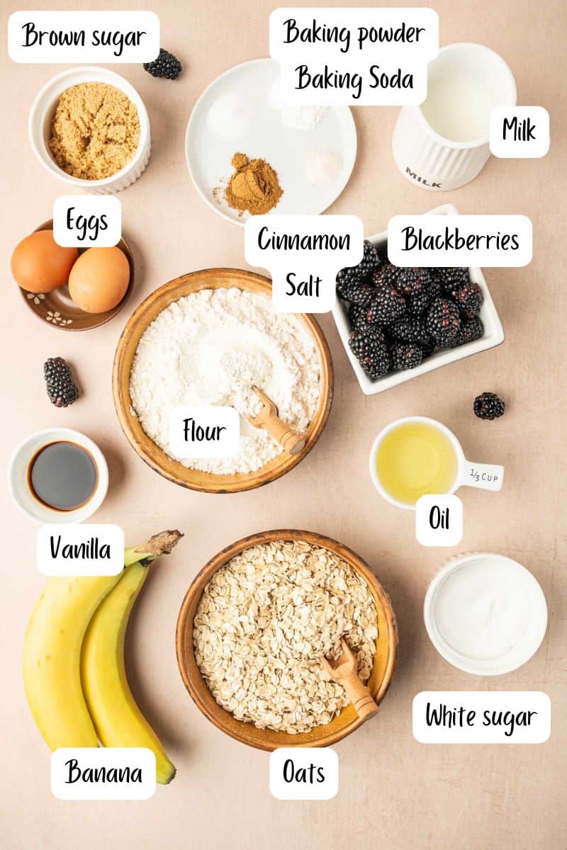 Ingredients laid out for banana blackberry oatmeal muffins in a warm backdrop.