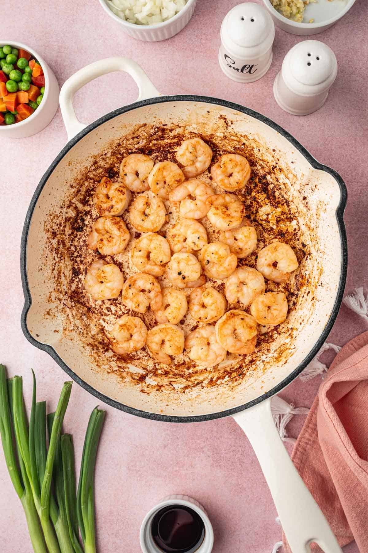 Cooked shrimp in a skillet for Chicken and shrimp fried rice recipe.